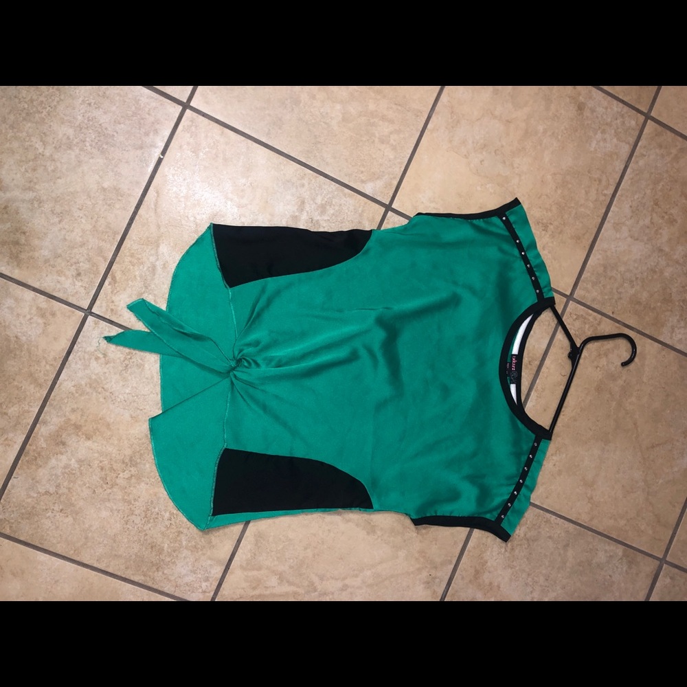 A green and black children’s shirt